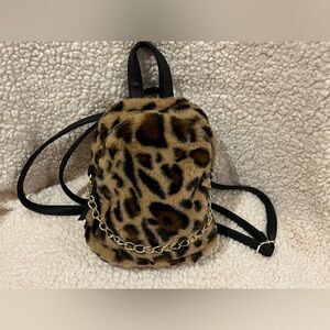 Leopard print faux fur mini backpack/ crossbody purse. Gold-tone hardware.
